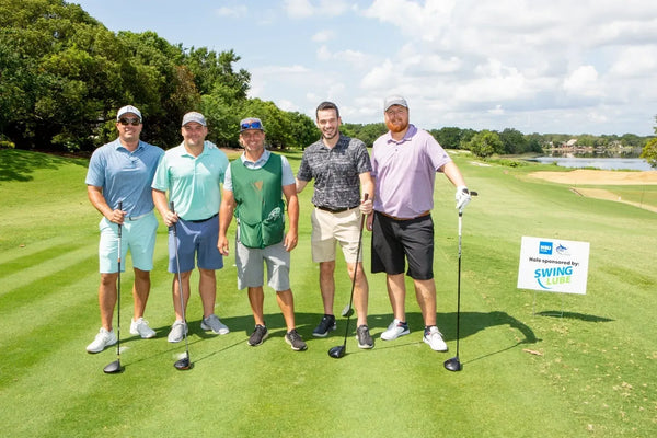A foursome at the Swing Lube sponsored hole